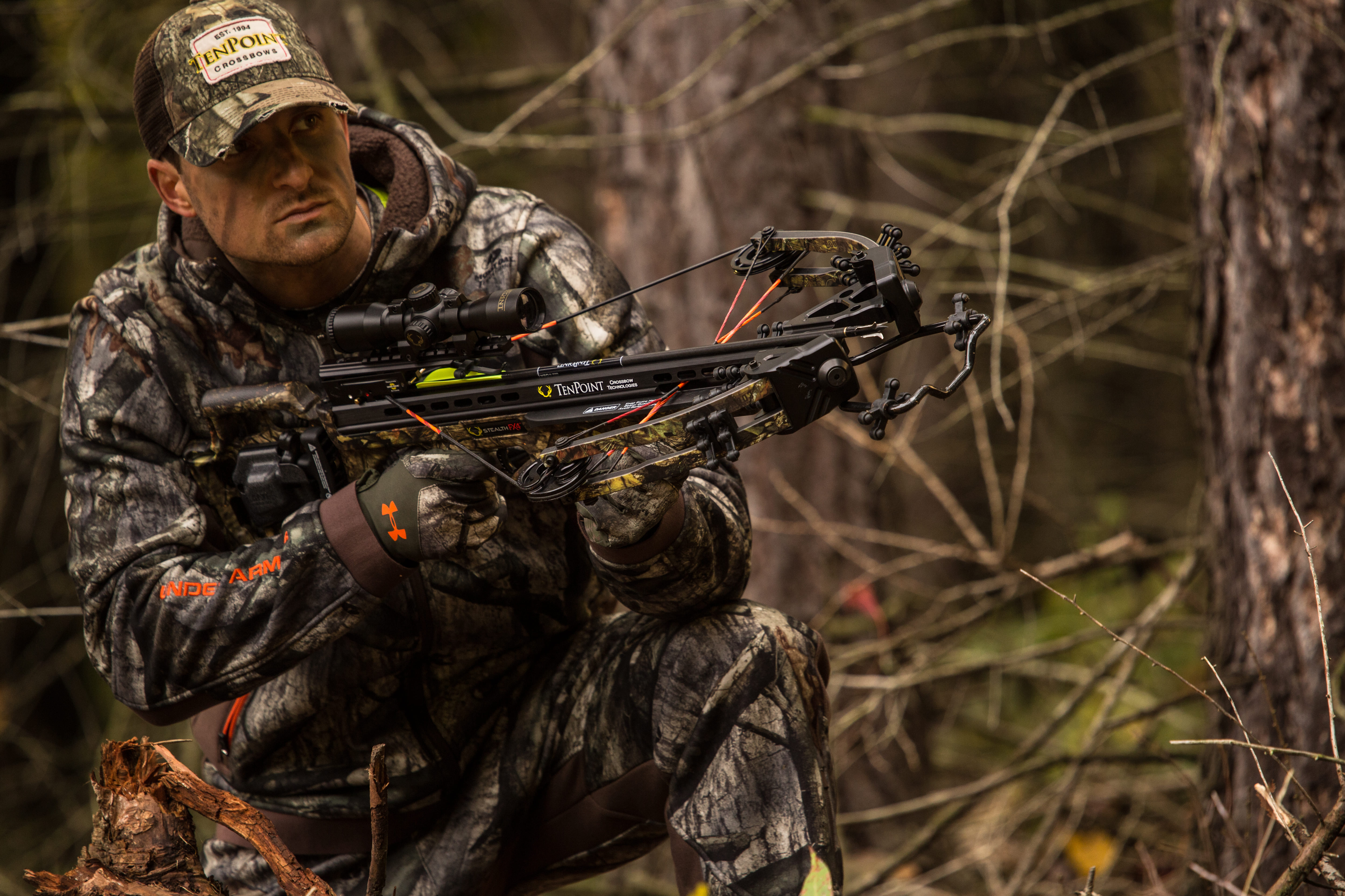 Hunter in the woods with a crossbow.